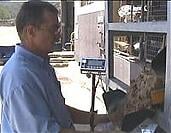 Using a machine to fill sand bags Using a machine to fill sand bags