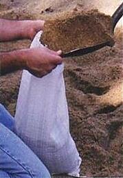 Filling sand bags by hand - watch those knuckles